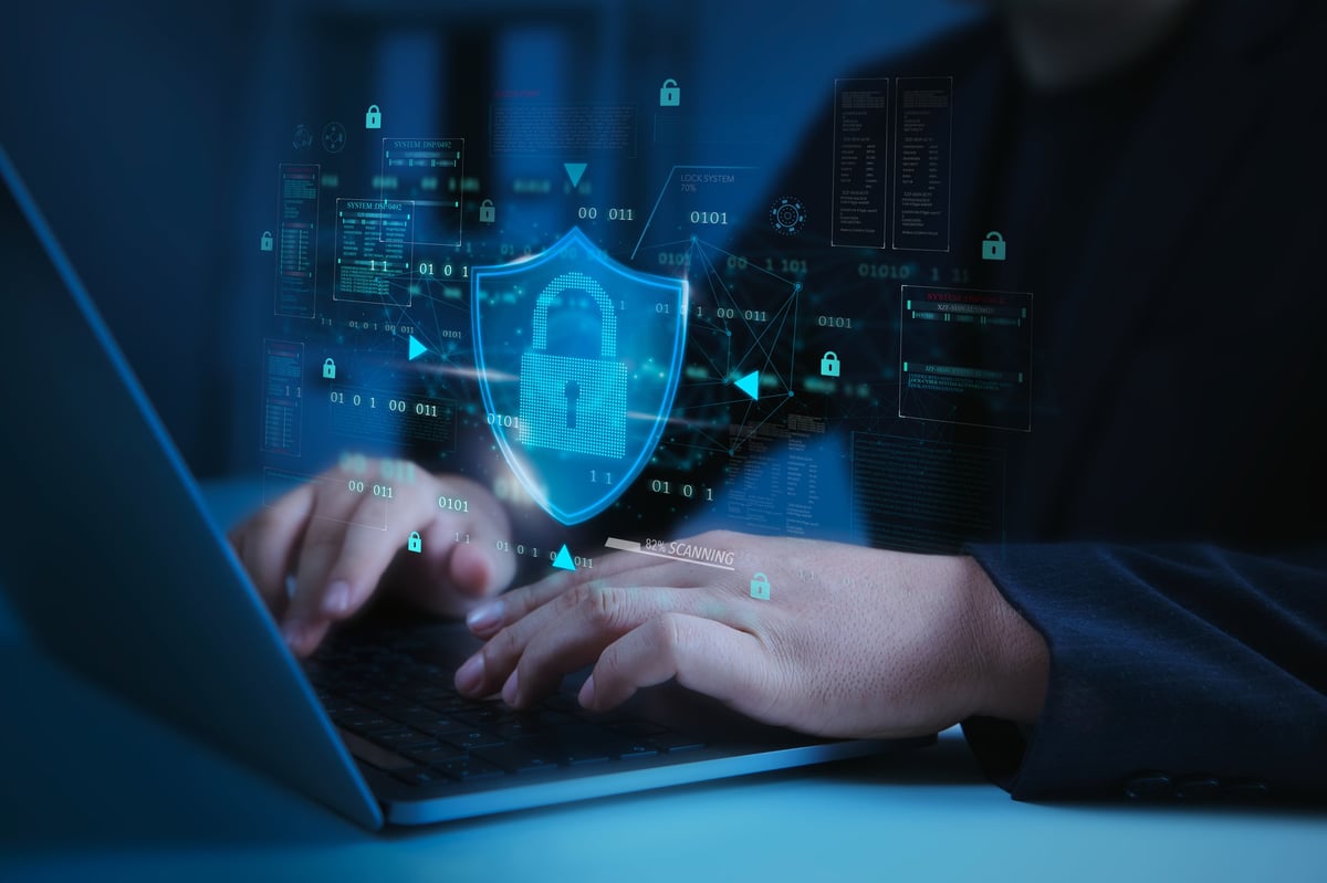 Cybersecurity shield lock securing data on a laptop with encryption for privacy and network defence
